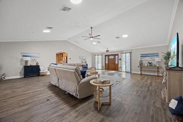 living room with ceiling fan, ornamental molding, dark wood-type flooring, and vaulted ceiling