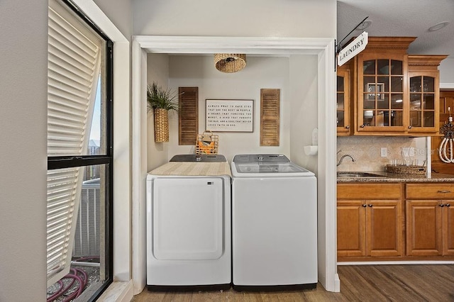 clothes washing area with washer and clothes dryer, dark hardwood / wood-style floors, sink, and a textured ceiling