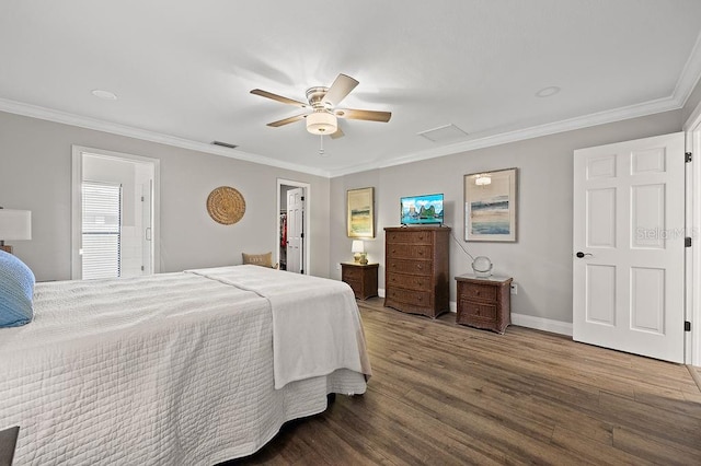 bedroom featuring a walk in closet, ceiling fan, hardwood / wood-style floors, and crown molding