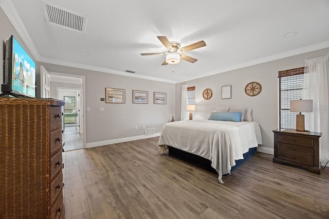 bedroom with hardwood / wood-style floors, ceiling fan, and ornamental molding