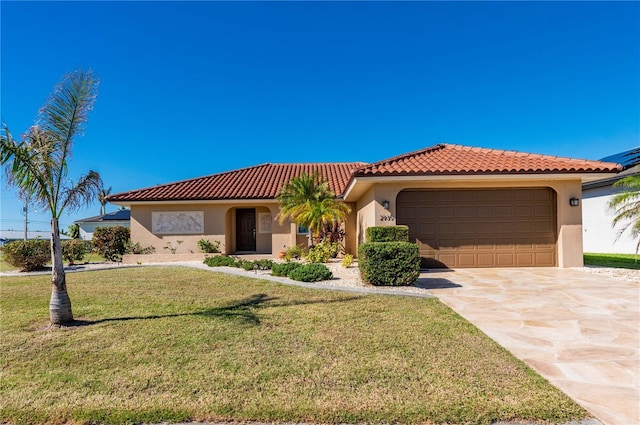 mediterranean / spanish-style home with a front yard and a garage