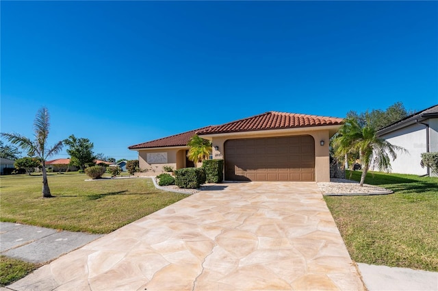 mediterranean / spanish-style home featuring a front yard and a garage