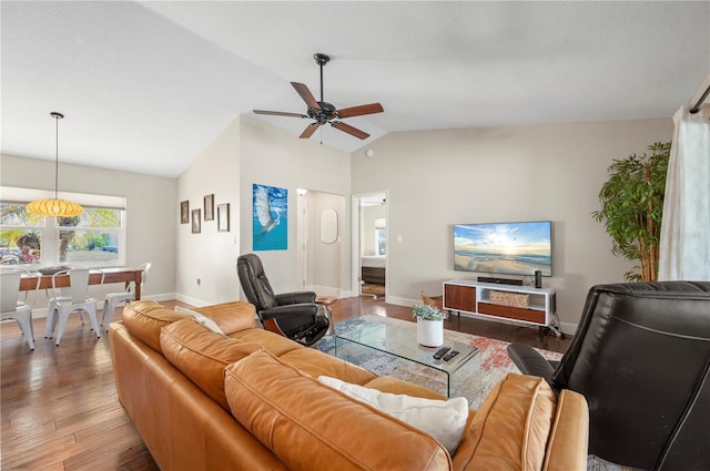 living room with ceiling fan, light hardwood / wood-style floors, and lofted ceiling