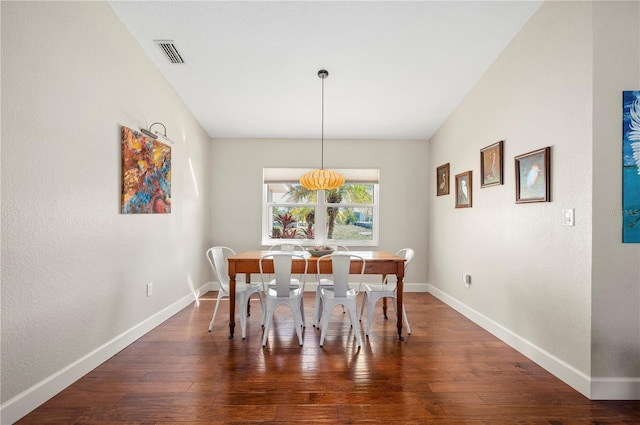 dining space featuring dark hardwood / wood-style flooring and lofted ceiling