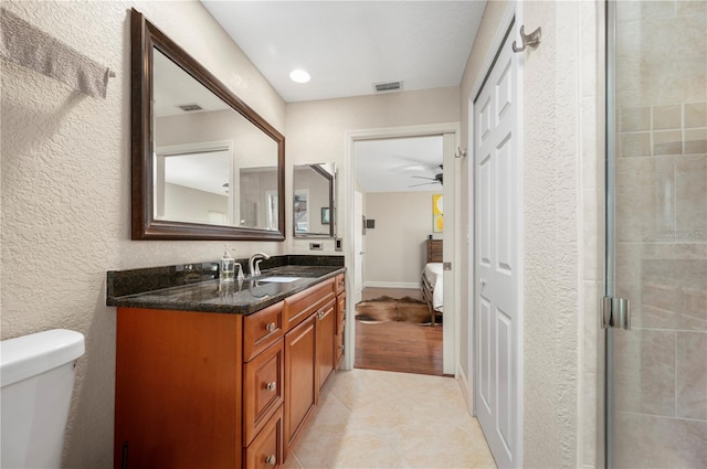 bathroom featuring vanity, toilet, wood-type flooring, and walk in shower