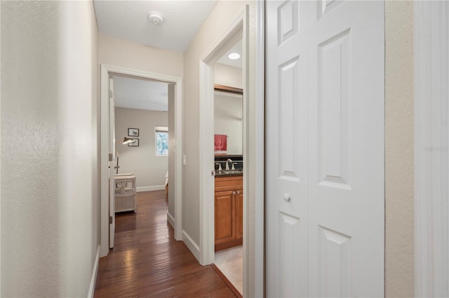 hallway featuring dark hardwood / wood-style floors and sink