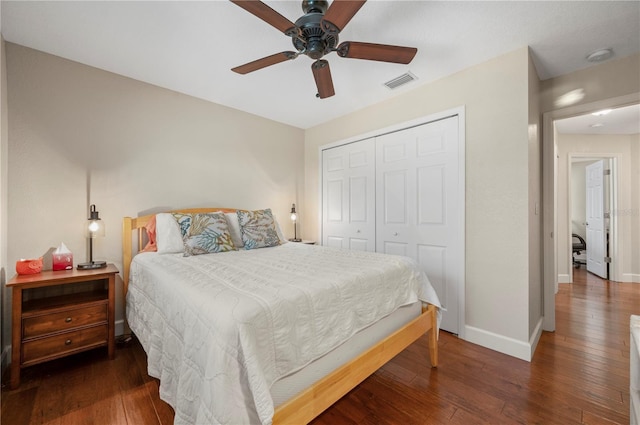 bedroom with a closet, dark hardwood / wood-style flooring, and ceiling fan