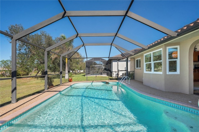 view of pool with a yard and a lanai