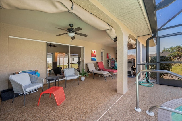 view of patio / terrace with ceiling fan and a lanai