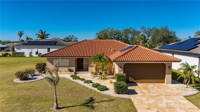 mediterranean / spanish house with a front lawn and a garage