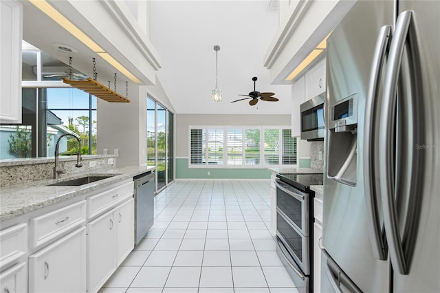 kitchen with white cabinets, appliances with stainless steel finishes, and sink