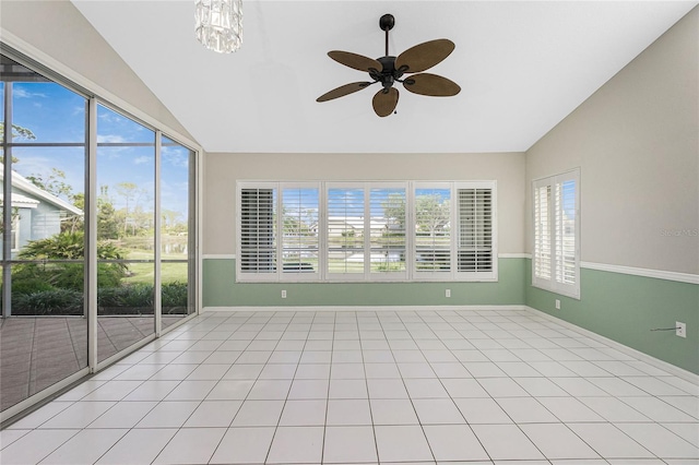 unfurnished sunroom with plenty of natural light, ceiling fan with notable chandelier, and lofted ceiling