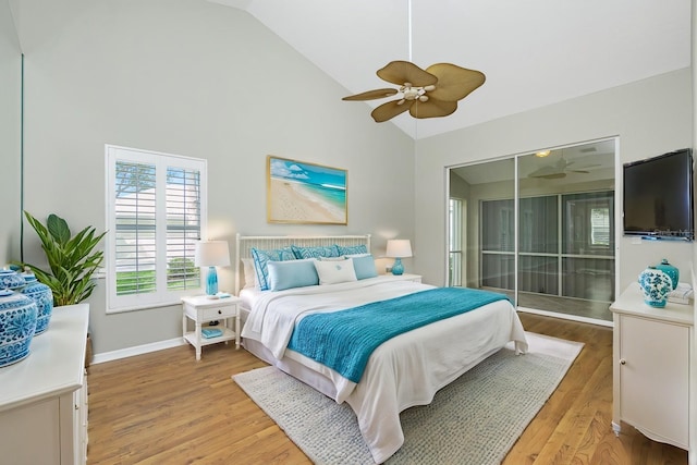 bedroom with ceiling fan, light wood-type flooring, and high vaulted ceiling