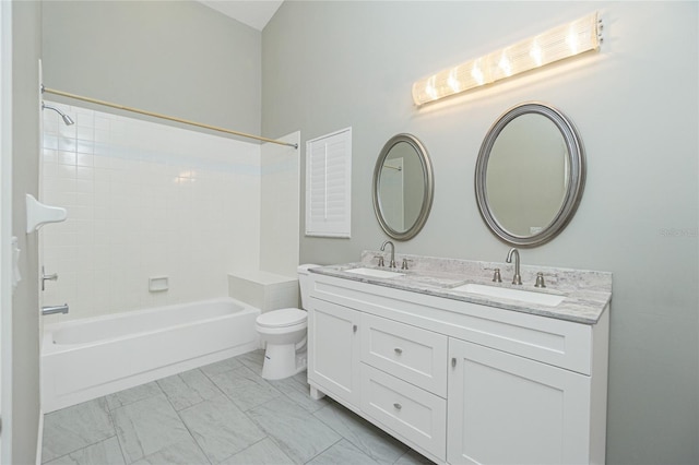 full bathroom featuring vanity, tiled shower / bath combo, and toilet