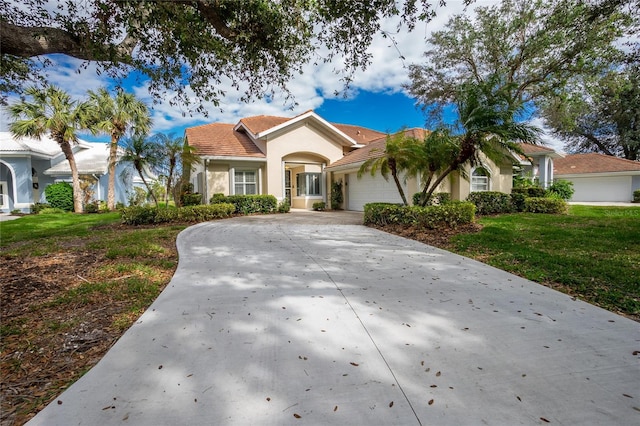 view of front of property featuring a garage and a front lawn