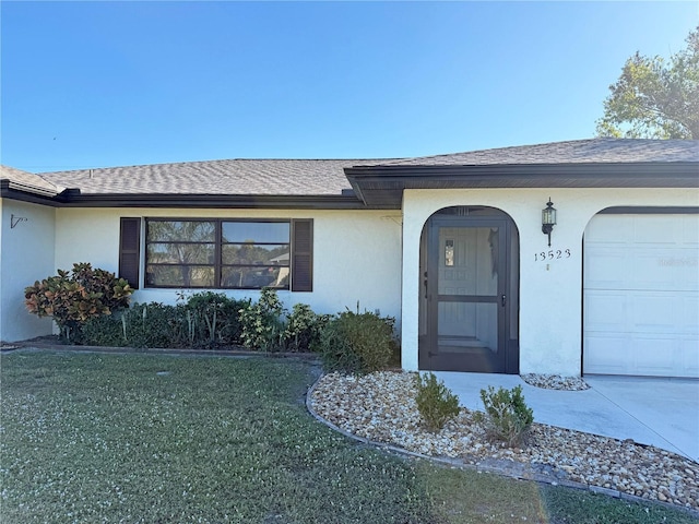 entrance to property with a lawn and a garage