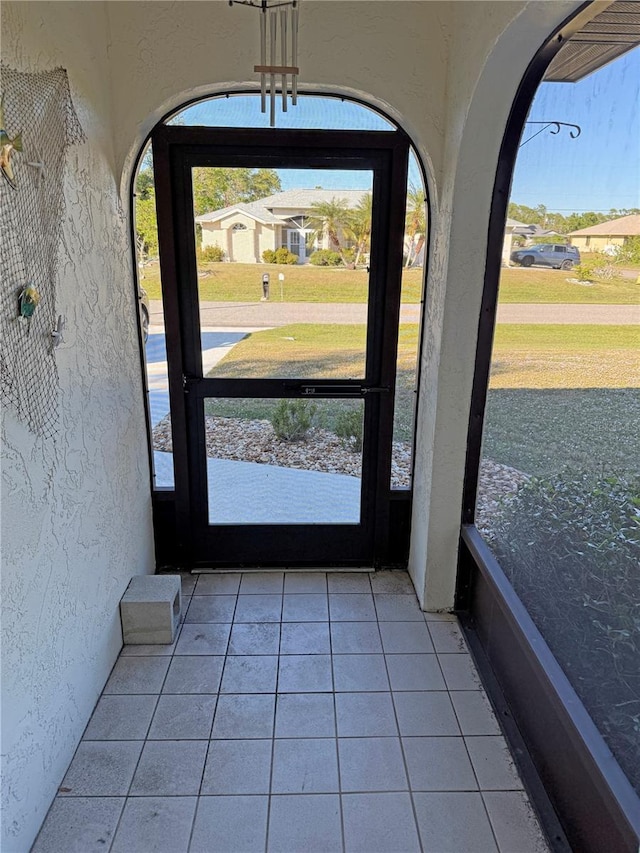 doorway featuring light tile patterned flooring