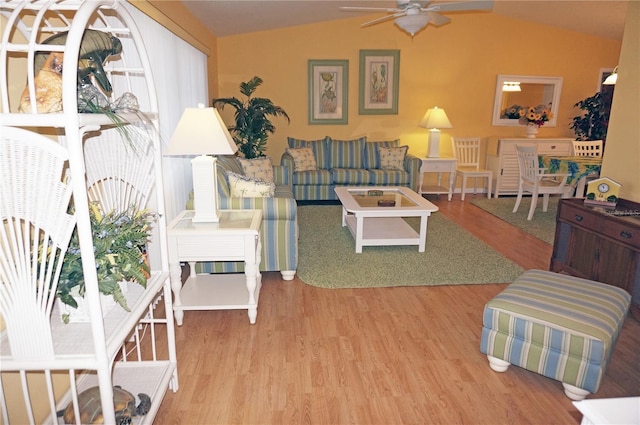 living room with wood-type flooring, vaulted ceiling, and ceiling fan