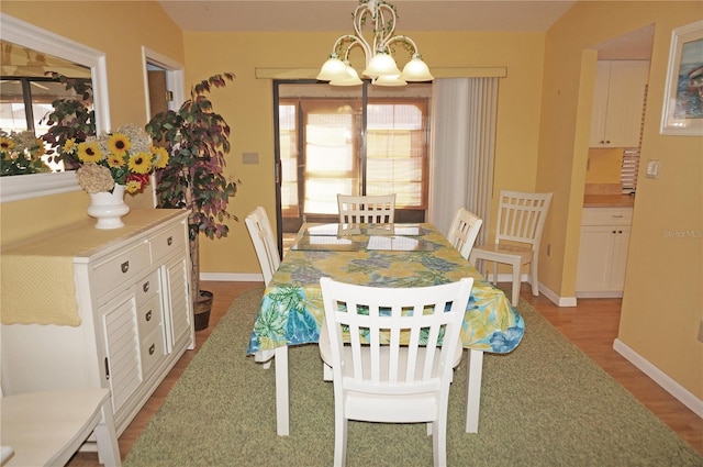 dining room featuring a chandelier and light hardwood / wood-style floors