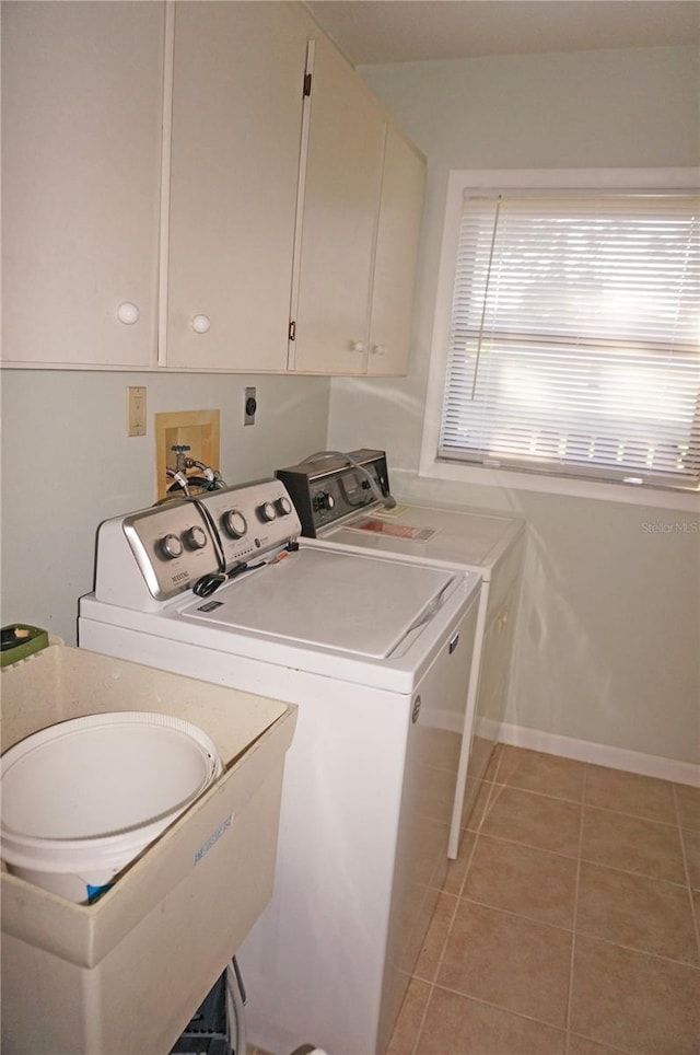 washroom featuring washer and dryer, light tile patterned floors, and sink