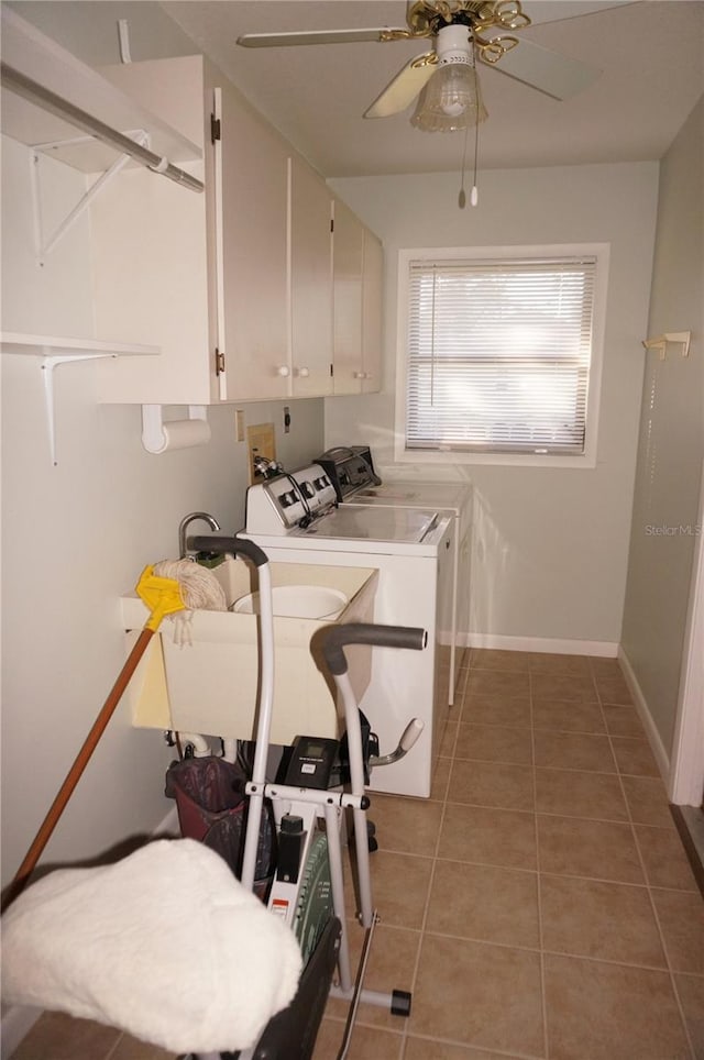 clothes washing area featuring washing machine and clothes dryer, ceiling fan, tile patterned flooring, and cabinets