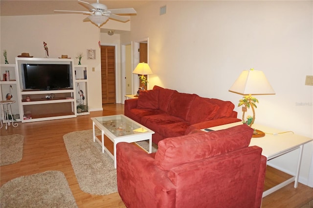 living room with hardwood / wood-style floors, vaulted ceiling, and ceiling fan