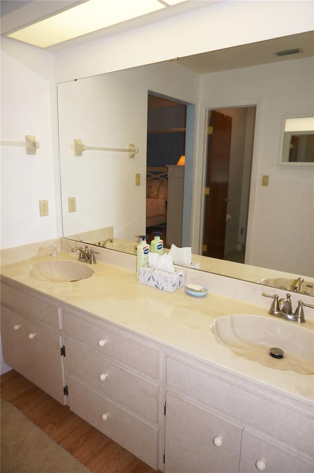 bathroom with vanity and wood-type flooring