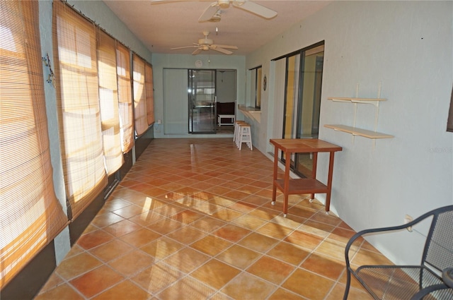 corridor with tile patterned flooring and a wealth of natural light