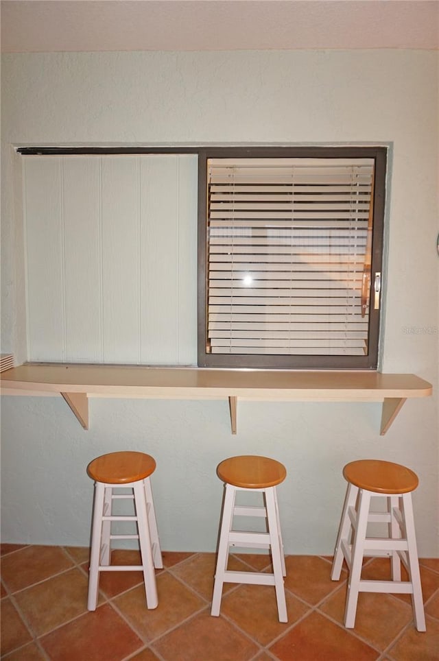 unfurnished dining area featuring tile patterned floors