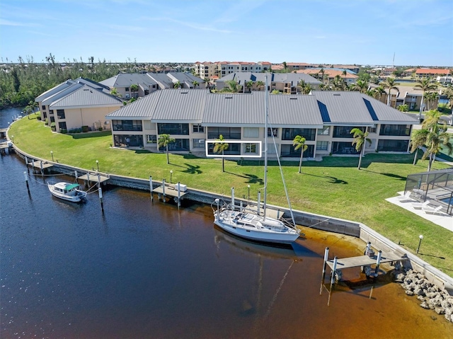 view of dock featuring a lawn and a water view