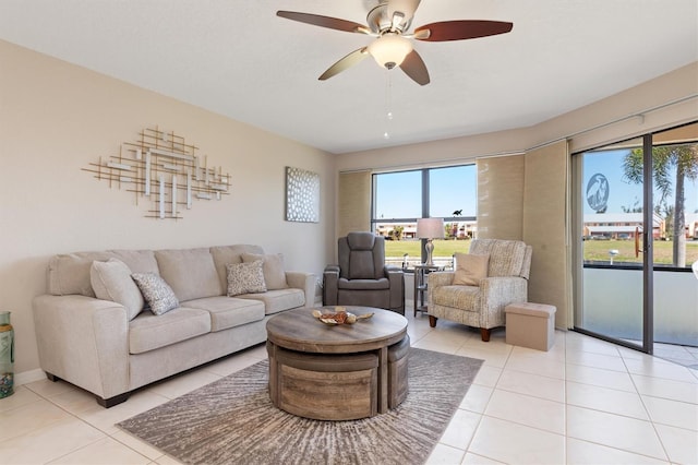 living room with ceiling fan and light tile patterned flooring