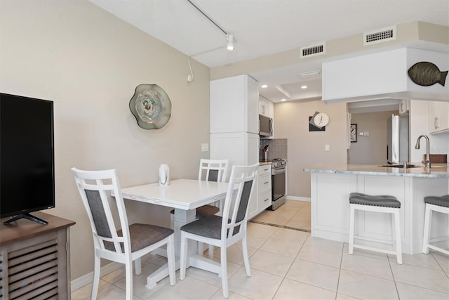 dining room with sink and light tile patterned floors