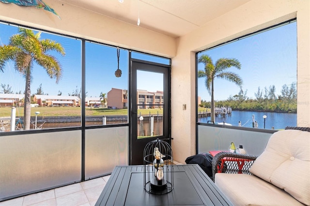 sunroom / solarium featuring a water view