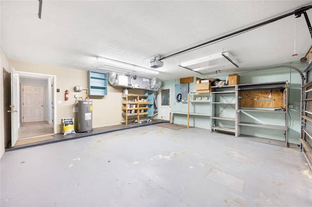 garage featuring electric water heater and a garage door opener