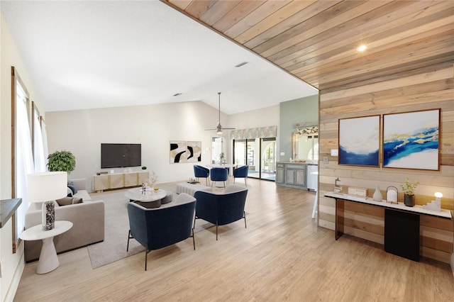 living room with light wood-type flooring, vaulted ceiling, ceiling fan, and wooden ceiling