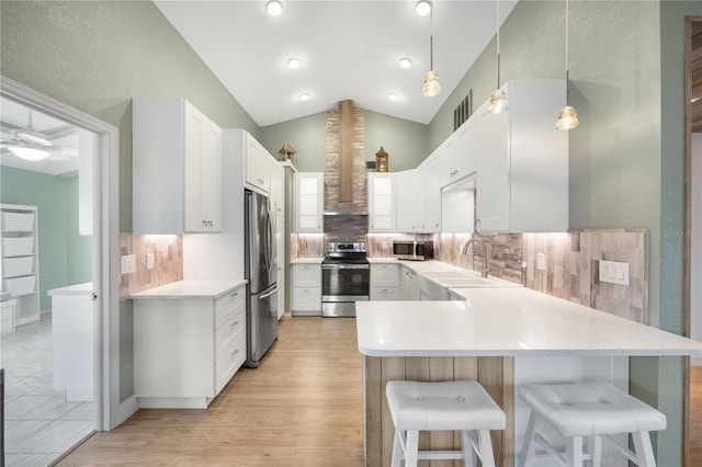 kitchen featuring pendant lighting, stainless steel appliances, white cabinetry, and sink