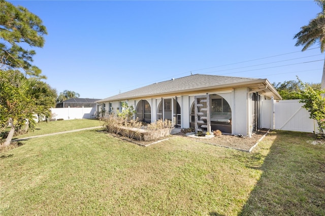 back of house featuring a lawn