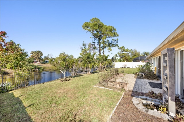 view of yard with a patio area and a water view