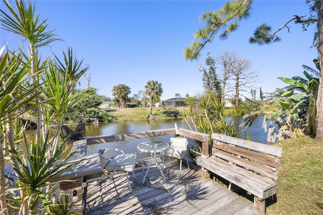 view of dock with a deck with water view