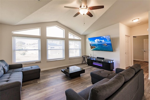 living room with hardwood / wood-style floors, vaulted ceiling, and ceiling fan