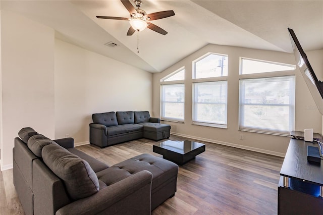 living room featuring ceiling fan, lofted ceiling, and hardwood / wood-style flooring