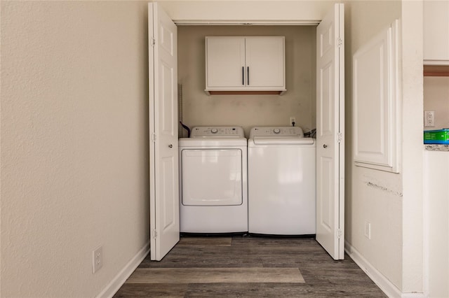 laundry room with cabinets, washer and dryer, and dark hardwood / wood-style flooring