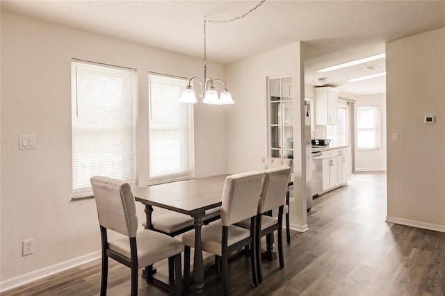 dining room featuring a chandelier and dark wood-type flooring