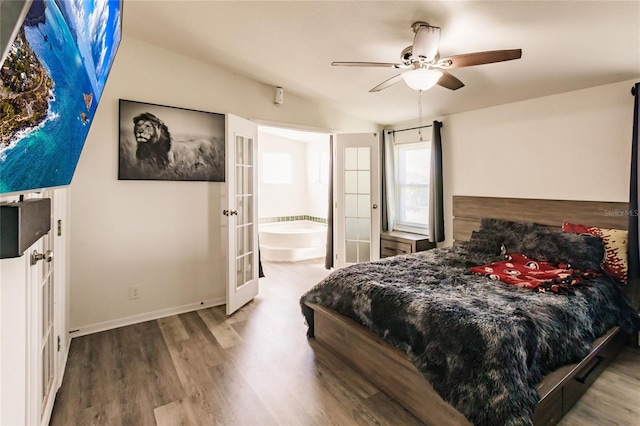 bedroom with french doors, vaulted ceiling, ceiling fan, hardwood / wood-style floors, and connected bathroom