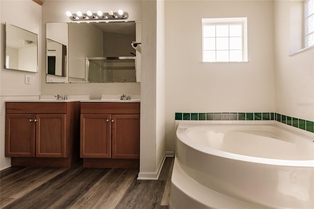 bathroom featuring vanity, separate shower and tub, and wood-type flooring