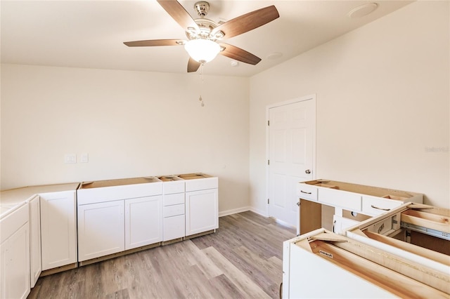 washroom with ceiling fan and light hardwood / wood-style flooring