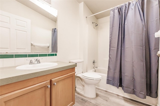 full bathroom with decorative backsplash, vanity, shower / tub combo with curtain, hardwood / wood-style flooring, and toilet