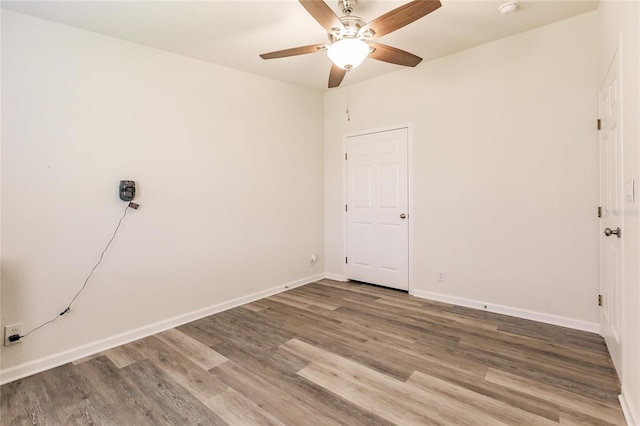 empty room with hardwood / wood-style flooring and ceiling fan