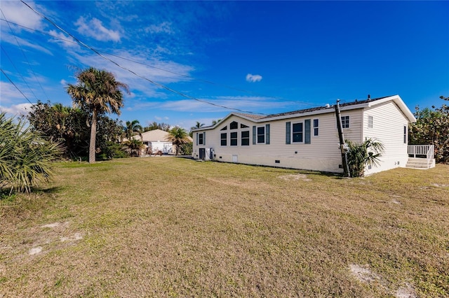 rear view of property with a yard