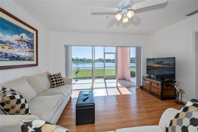 living room featuring hardwood / wood-style flooring and ceiling fan